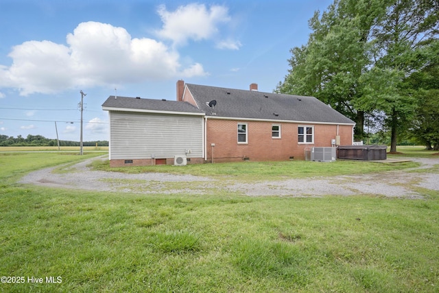 1047 US Highway 158 W, Gates, NC 27937 - back of property with a hot tub, crawl space, a lawn, a chimney, and brick siding