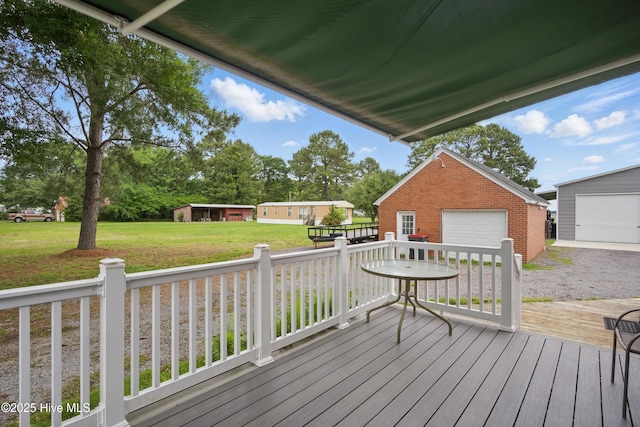 1047 US Highway 158 W, Gates, NC 27937 - deck with a detached garage, an outdoor structure, and a yard