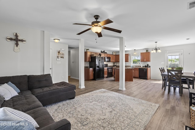 112 Silver Queen Ln, Richlands, NC 28574 - living area with a chandelier, a ceiling fan, light wood-type flooring, and baseboards