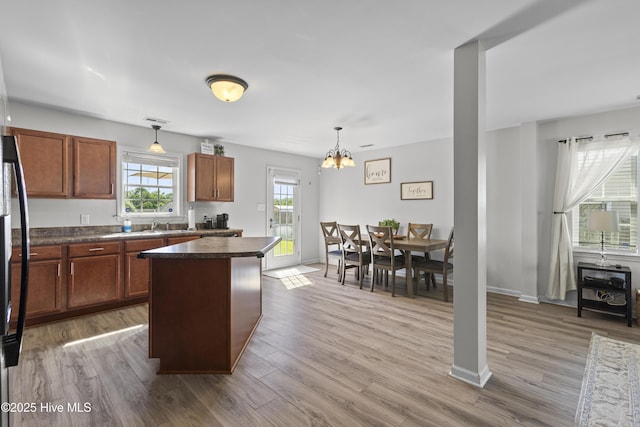 112 Silver Queen Ln, Richlands, NC 28574 - kitchen featuring dark countertops, a chandelier, wood finished floors, and decorative light fixtures