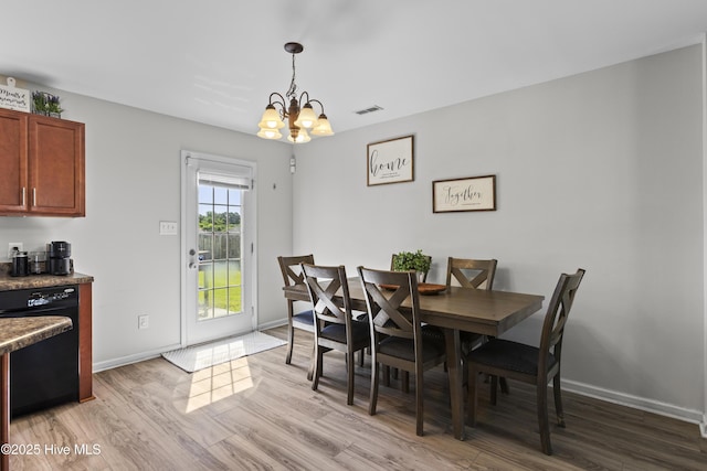 112 Silver Queen Ln, Richlands, NC 28574 - dining space featuring a chandelier, light wood-style flooring, and baseboards