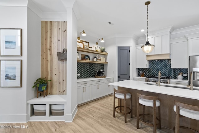 510 White Picket Way, Holly Ridge, NC 28445 - kitchen with decorative backsplash, a kitchen bar, light countertops, open shelves, and ornamental molding