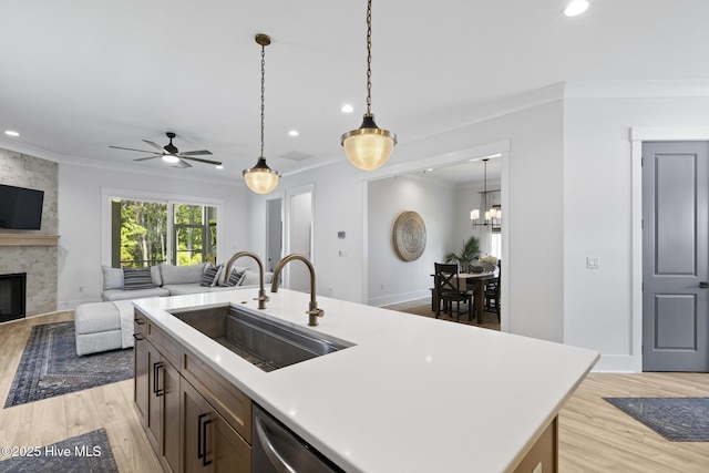 510 White Picket Way, Holly Ridge, NC 28445 - kitchen with a sink, crown molding, open floor plan, light wood-style flooring, and ceiling fan