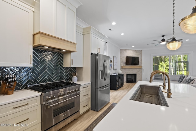 510 White Picket Way, Holly Ridge, NC 28445 - kitchen featuring stainless steel appliances, a sink, open floor plan, light countertops, and crown molding