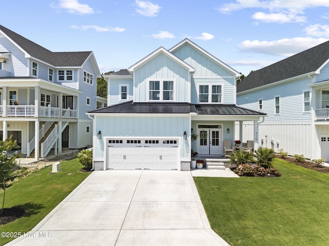 510 White Picket Way, Holly Ridge, NC 28445 - view of front facade featuring board and batten siding, concrete driveway, a front yard, an attached garage, and metal roof