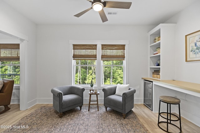 510 White Picket Way, Holly Ridge, NC 28445 - living area featuring beverage cooler, light wood finished floors, a ceiling fan, and baseboards