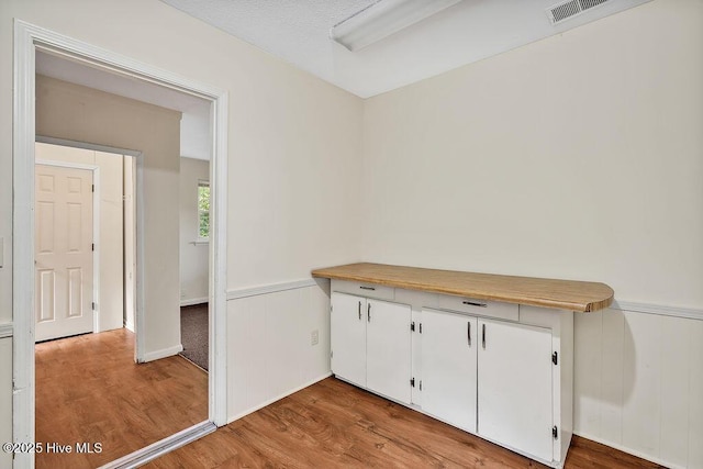 326 Spartan Rd, Wilmington, NC 28405 - empty room featuring light wood-style floors and a wainscoted wall