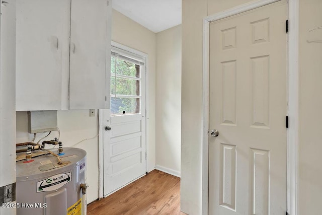 326 Spartan Rd, Wilmington, NC 28405 - entryway featuring water heater, light wood-style flooring, and baseboards