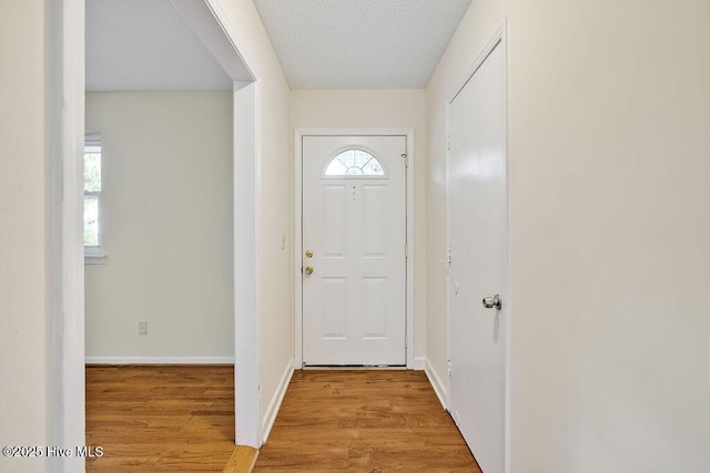 326 Spartan Rd, Wilmington, NC 28405 - entrance foyer with light wood-style floors, baseboards, and a textured ceiling
