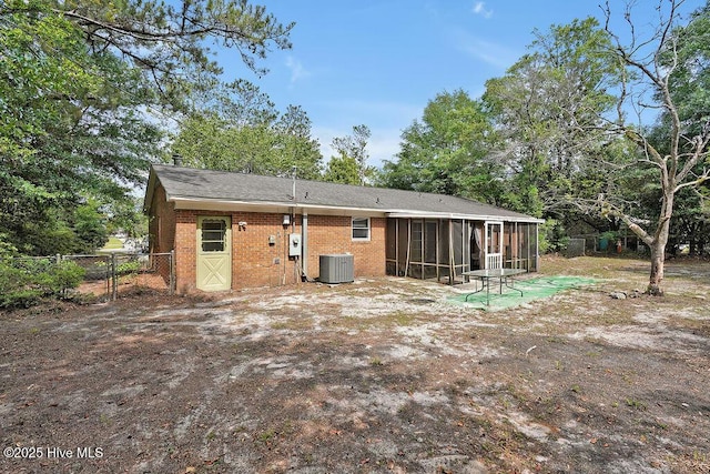 326 Spartan Rd, Wilmington, NC 28405 - back of property with a sunroom, brick siding, fence, and central air condition unit