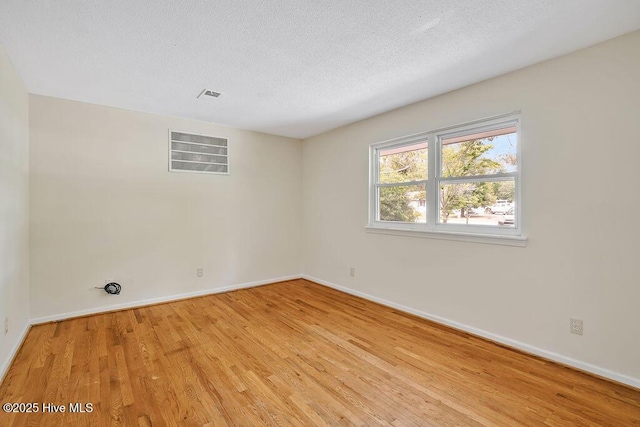 326 Spartan Rd, Wilmington, NC 28405 - empty room with light wood-style floors, baseboards, and a textured ceiling