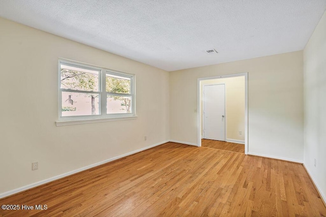 326 Spartan Rd, Wilmington, NC 28405 - empty room featuring light wood-type flooring, baseboards, and a textured ceiling