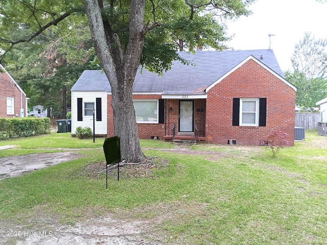 303 S Andrews Ave, Goldsboro, NC 27530 - view of front of home featuring brick siding, a front yard, cooling unit, and a shingled roof
