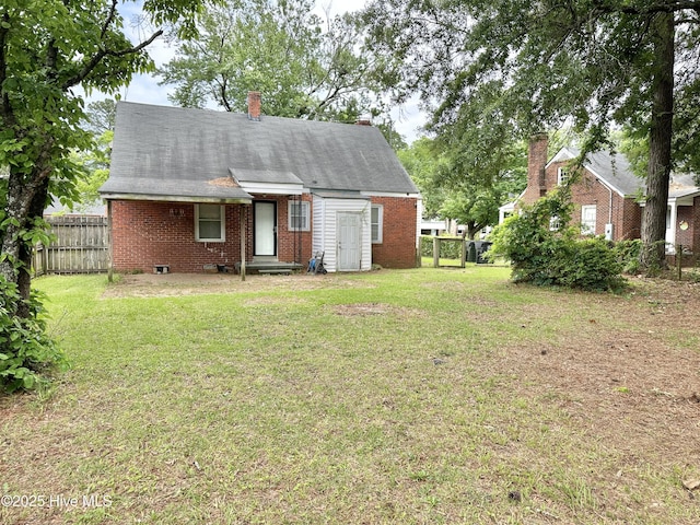 303 S Andrews Ave, Goldsboro, NC 27530 - back of house with brick siding, a chimney, and entry steps