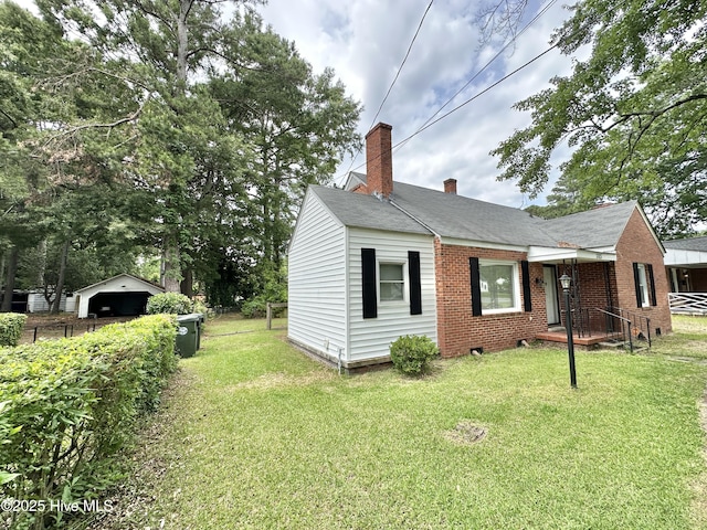303 S Andrews Ave, Goldsboro, NC 27530 - view of side of property with a chimney and brick siding