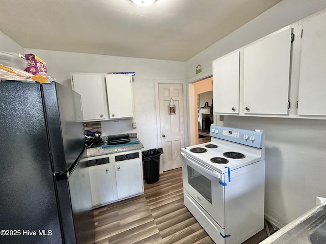 303 S Andrews Ave, Goldsboro, NC 27530 - kitchen featuring freestanding refrigerator, white electric range oven, white cabinets, wood finished floors, and light countertops