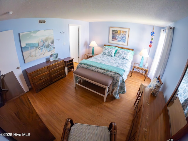 1505 Salter Path Rd Unit 319, Indian Beach, NC 28512 - bedroom with wood finished floors and a textured ceiling