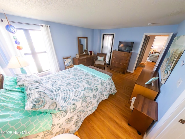 1505 Salter Path Rd Unit 319, Indian Beach, NC 28512 - bedroom with wood finished floors, a textured ceiling, and baseboards