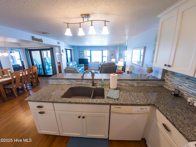 1505 Salter Path Rd Unit 319, Indian Beach, NC 28512 - kitchen featuring dishwasher, open floor plan, a sink, wood finished floors, and a peninsula