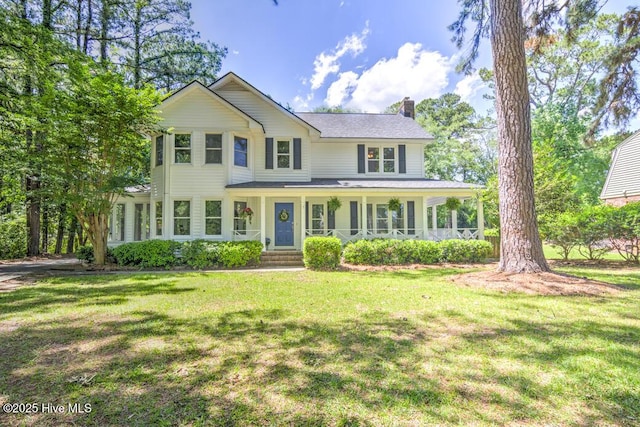 2428 Tram Rd, New Bern, NC 28562 - view of front facade featuring a chimney, covered porch, and a front yard