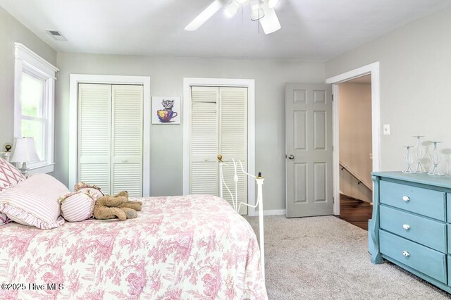 2428 Tram Rd, New Bern, NC 28562 - bedroom with two closets, light colored carpet, ceiling fan, and baseboards