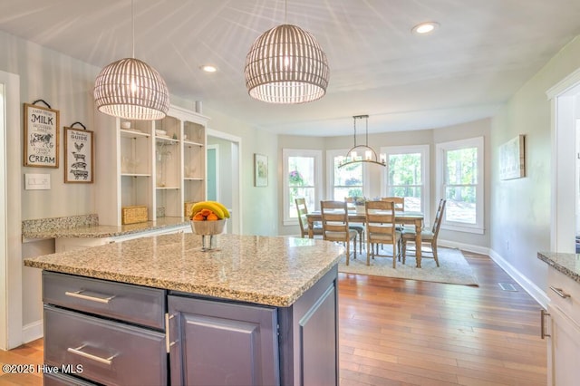 2428 Tram Rd, New Bern, NC 28562 - kitchen featuring hardwood / wood-style floors, recessed lighting, baseboards, a kitchen island, and pendant lighting