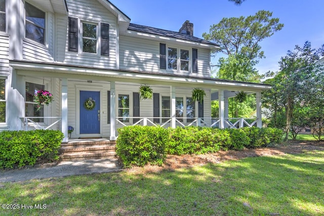 2428 Tram Rd, New Bern, NC 28562 - view of front of home featuring a chimney, a front yard, and a porch