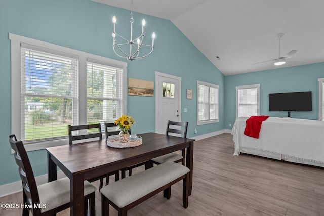 492 Jabbertown Rd, Southport, NC 28461 - dining room featuring a chandelier, light wood-style flooring, high vaulted ceiling, and baseboards