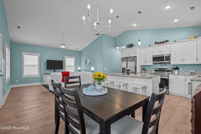 492 Jabbertown Rd, Southport, NC 28461 - dining area with light wood-style flooring, a chandelier, a ceiling fan, baseboards, and high vaulted ceiling