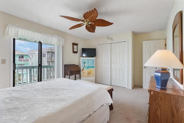 1008 Canal Dr Unit 3A, Carolina Beach, NC 28428 - carpeted bedroom featuring access to exterior, a closet, a textured ceiling, and ceiling fan