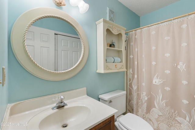 1008 Canal Dr Unit 3A, Carolina Beach, NC 28428 - full bathroom with vanity, toilet, curtained shower, and a textured ceiling