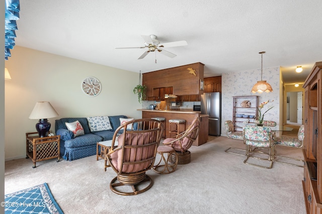 1008 Canal Dr Unit 3A, Carolina Beach, NC 28428 - living area featuring ceiling fan, light carpet, and wallpapered walls