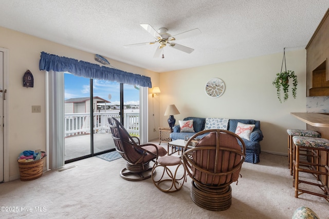 1008 Canal Dr Unit 3A, Carolina Beach, NC 28428 - living room with carpet, ceiling fan, and a textured ceiling