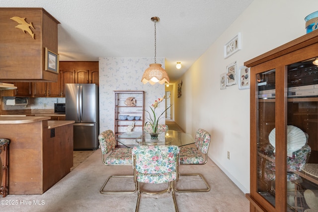 1008 Canal Dr Unit 3A, Carolina Beach, NC 28428 - dining space featuring light carpet, a textured ceiling, wallpapered walls, and baseboards
