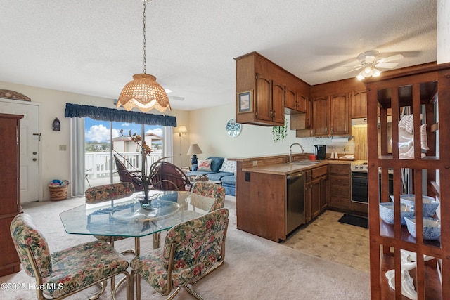 1008 Canal Dr Unit 3A, Carolina Beach, NC 28428 - kitchen with a sink, stainless steel dishwasher, light colored carpet, a textured ceiling, and brown cabinets