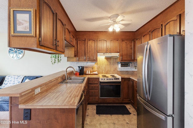 1008 Canal Dr Unit 3A, Carolina Beach, NC 28428 - kitchen featuring stainless steel appliances, under cabinet range hood, a sink, ceiling fan, and wood counters