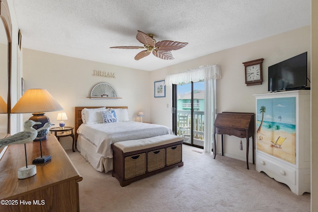 1008 Canal Dr Unit 3A, Carolina Beach, NC 28428 - bedroom featuring access to exterior, light colored carpet, a textured ceiling, and ceiling fan
