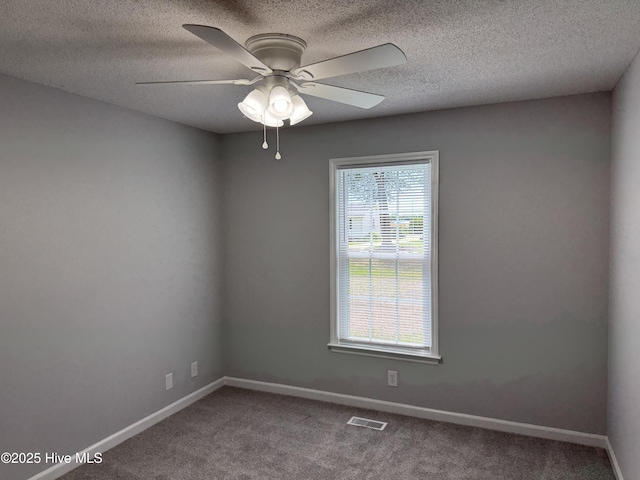 empty room featuring carpet floors, a ceiling fan, baseboards, and a textured ceiling