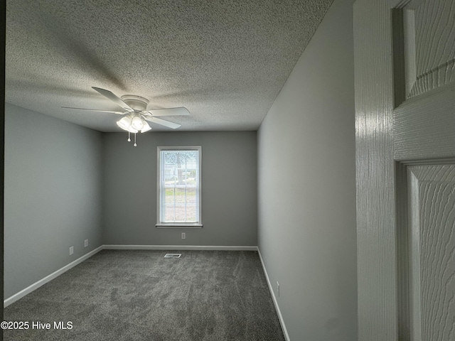 carpeted spare room with a ceiling fan, baseboards, and a textured ceiling