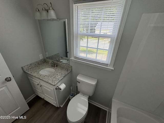 full bath featuring baseboards, toilet, wood finished floors, and vanity