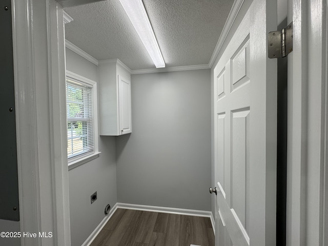 clothes washing area featuring cabinet space, electric dryer hookup, dark wood finished floors, a textured ceiling, and ornamental molding