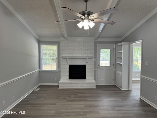 unfurnished living room with beamed ceiling, a ceiling fan, a textured ceiling, dark wood-type flooring, and a fireplace