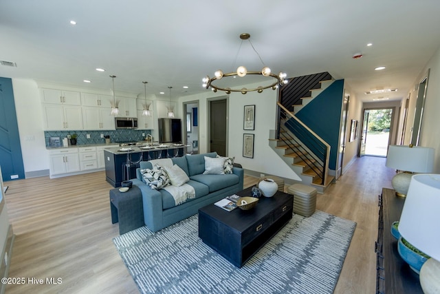 120 Fairview Rd, Leland, NC 28451 - living room featuring stairway, a chandelier, light wood-type flooring, and recessed lighting