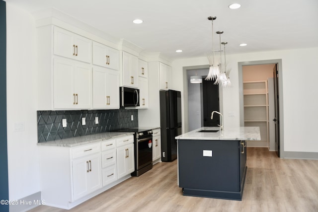 120 Fairview Rd, Leland, NC 28451 - kitchen featuring black appliances, a sink, light wood-type flooring, tasteful backsplash, and white cabinets