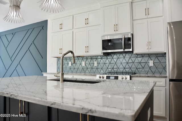 120 Fairview Rd, Leland, NC 28451 - kitchen featuring appliances with stainless steel finishes, backsplash, white cabinetry, and a sink