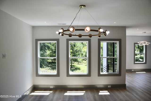 120 Fairview Rd, Leland, NC 28451 - unfurnished dining area with a chandelier, plenty of natural light, and wood finished floors