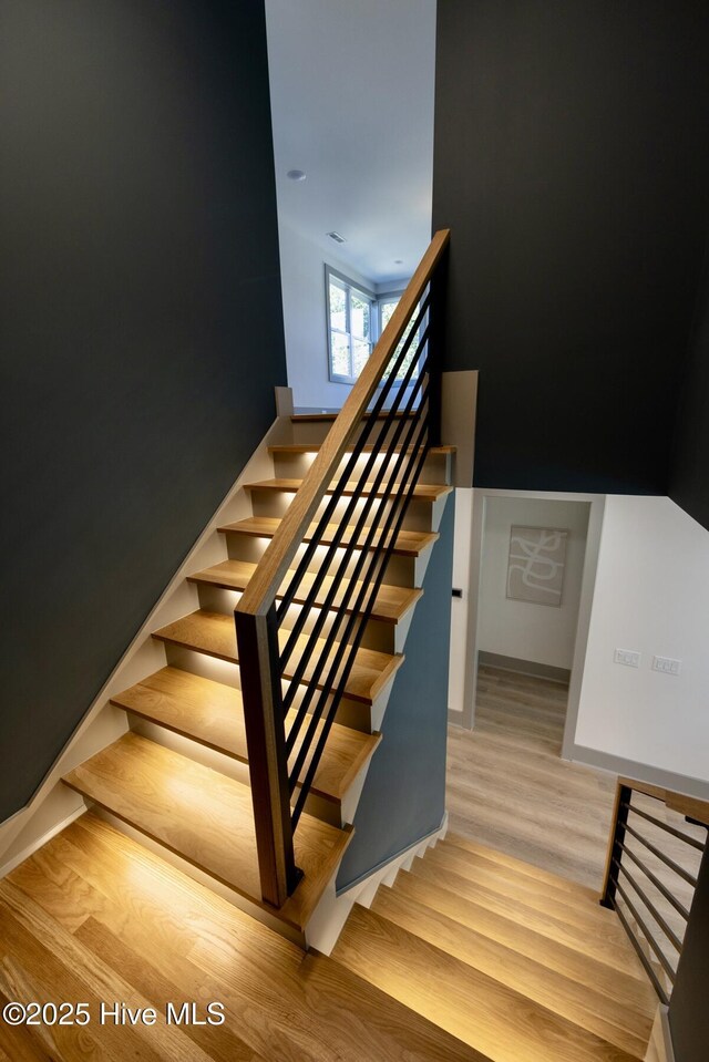 120 Fairview Rd, Leland, NC 28451 - stairs featuring wood finished floors and baseboards