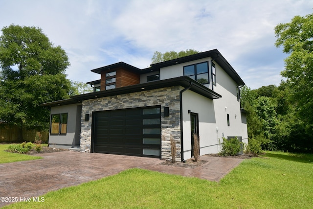 120 Fairview Rd, Leland, NC 28451 - modern home with stone siding, stucco siding, a front yard, and driveway