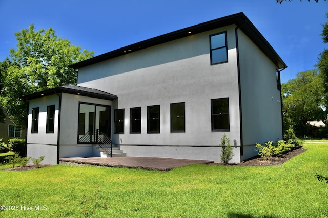 120 Fairview Rd, Leland, NC 28451 - back of property with a yard, stucco siding, a patio area, and entry steps