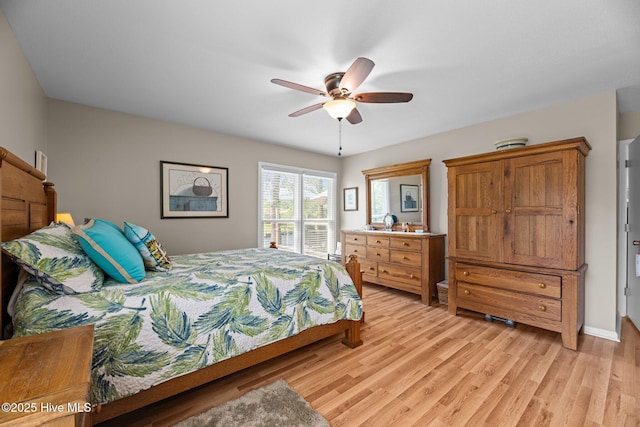 6008 Cassowary Ln, New Bern, NC 28560 - bedroom with light wood-style flooring, a ceiling fan, and baseboards